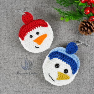 crochet snowman ornament with red and blue hats
