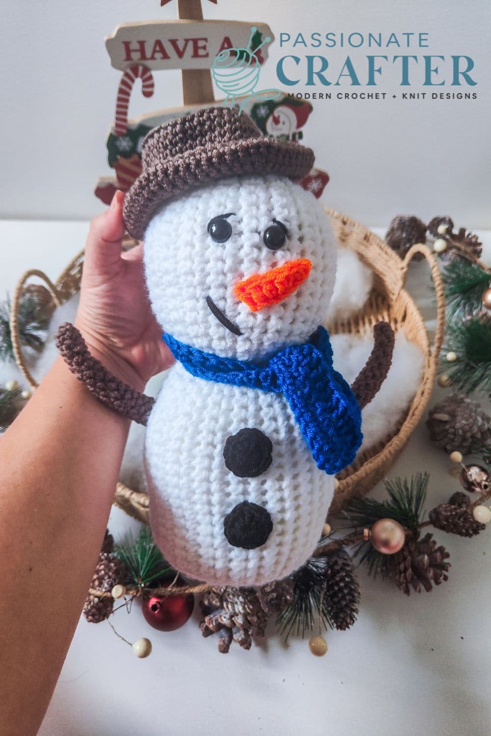 Free crochet Snowman pattern for beginners with a blue scarf and brown hat